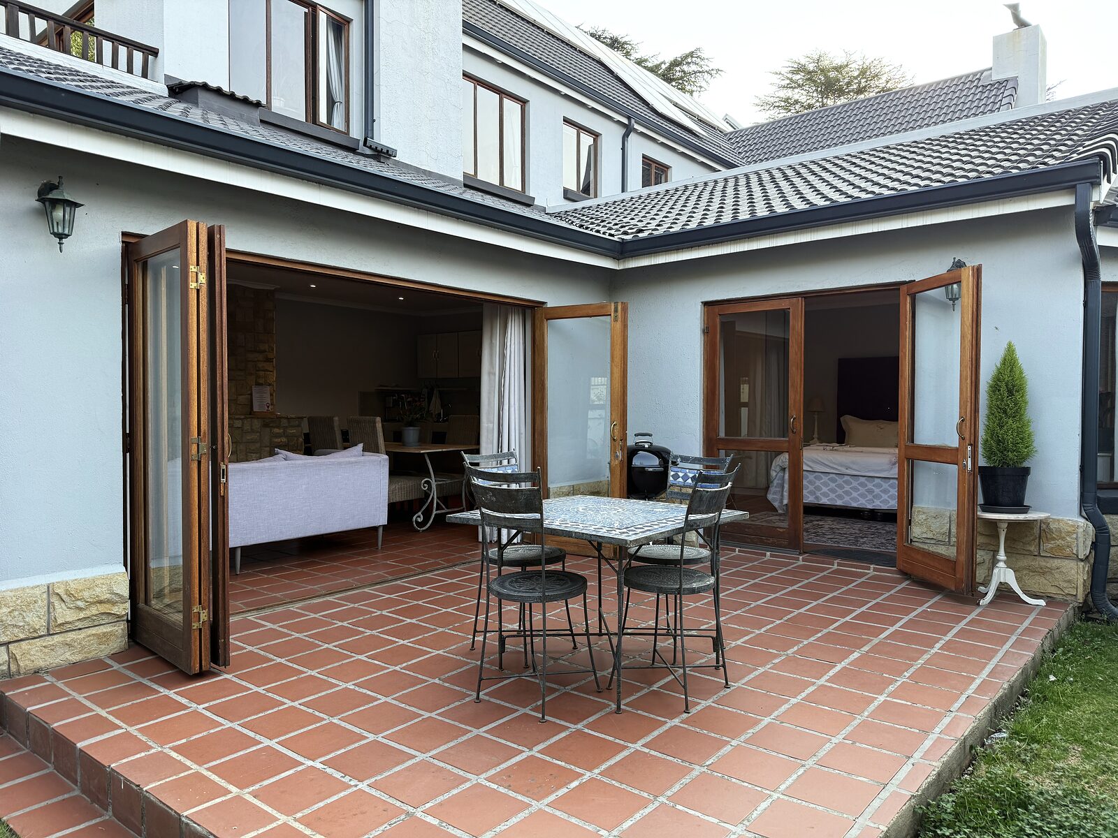 The Studio — A one-bedroom cottage tucked behind the shop, with a corner bath and a private garden patio.